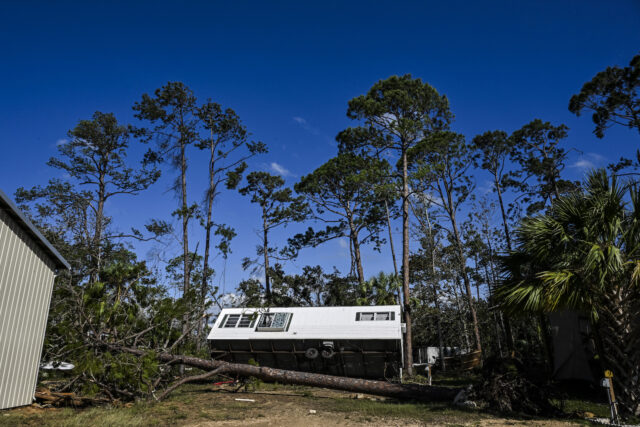 A mobile home is seen among trees after Hurricane Helene