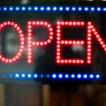 Blue and red neo light open sign on a store window, used in a post about Philippines sari-sari ERP Packworks