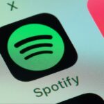 Spotify, Apple Music on smart phone screen.