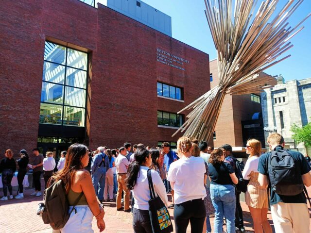 Students gather on a sunny US college campus.