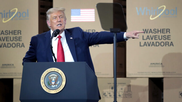 Photo of Trump giving a speech in front of boxes of Whirlpool appliances