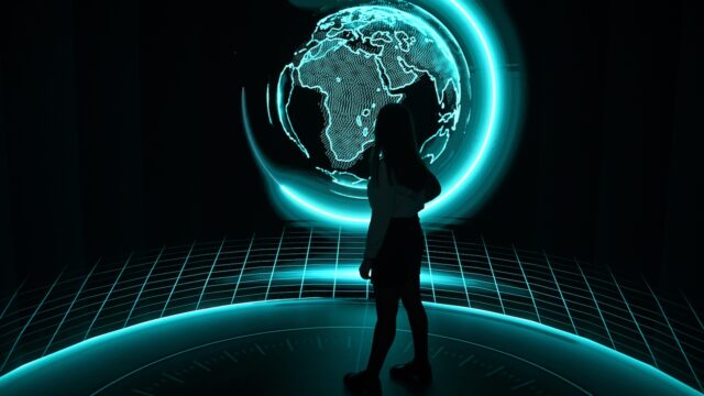 A visitor to COP29 is seen in silhouette against an illuminated globe of the world in the Zero Waste pavillion at the COP meeting in Baku, Azerbaijan.