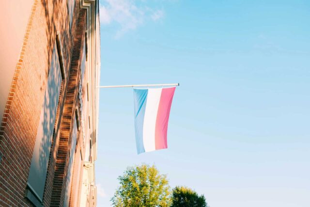 The Netherlands flag against the sky.