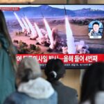 People watch a television screen showing a news broadcast with file footage of a North Korean missile test, at a railway station in Seoul on April 22, 2024. North Korea has fired an unidentified ballistic missile into the sea off South Korea's east coast.