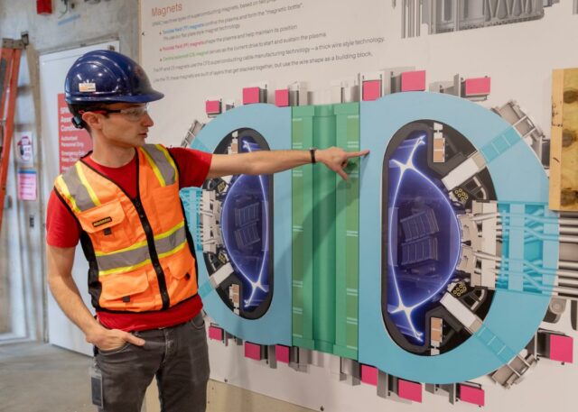 Alex Creely, director of Tokamak operations at Commonwealth Fusion Systems, points to a reactor schematic.