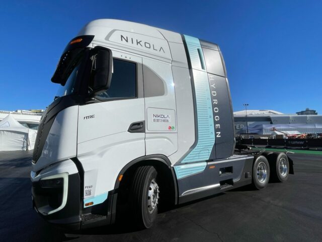 A white, blue and gray Nikola hydrogen-powered truck on display outside at CES 2024 in Las Vegas.