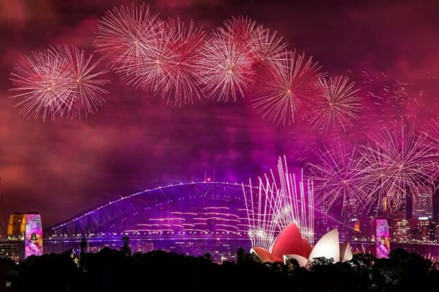 fireworks light up the sky above the sydney harbour bridge and sydney opera house as new year s eve celebrations begin around the world photo afp