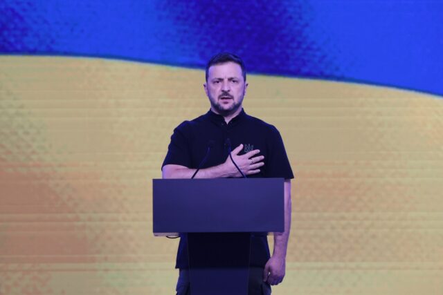 Volodymyr Zelenskyi, President of Ukraine, holds his hand over his heart during the performance of the national anthem of Ukraine at the VII Annual International Veterans Forum ‘Ukraine. Veterans. Unity’ on August 22, 2024 in Kyiv, Ukraine.