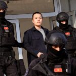 Montenegrin police officers of the PJP (Special Police Unit) escort South Korean cryptocurrency entrepreneur Do Kwon (C) at the exit of a court in Podgorica, Montenegro