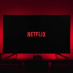 netflix logo on black screen backlit by red glow