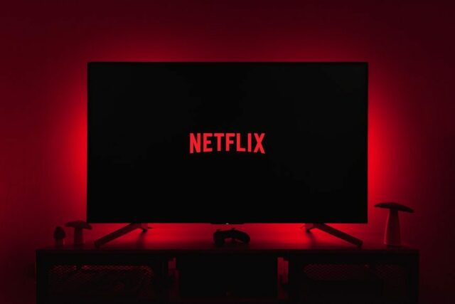 netflix logo on black screen backlit by red glow