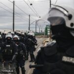 a photo of Serbian police units in riot gear guard the entrance to the Old Sava Bridge in Belgrade on November 20, 2024, during of a protest