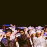 Group of graduating students wearing university gowns.