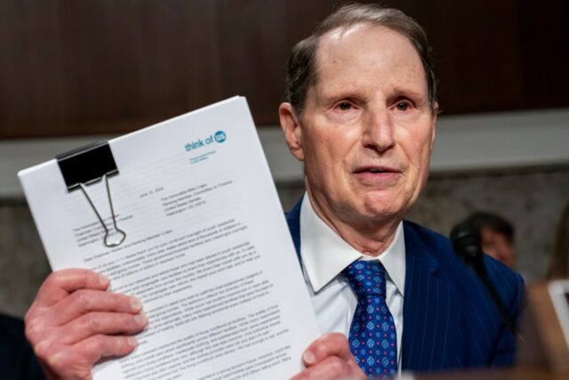 Sen. Ron Wyden (D-OR) holds up witness testimony during a Senate Finance Committee hearing on abuse at youth residential treatment facilities at the U.S. Capitol on June 12, 2024 in Washington, DC.