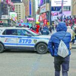 people walk through times square in manhattan photo afp