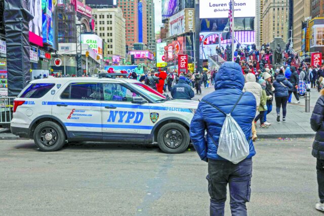 people walk through times square in manhattan photo afp