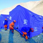 rescuers erect aid tents for people evacuated after an earthquake at cuoguo township in shigatse china s tibet region photo afp