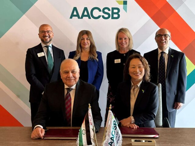 Representatives of business schools and the Arab Universities signing an agreement.