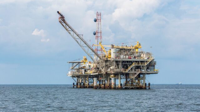 Floating three levels of machinery on ocean.