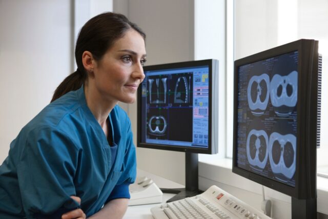 Doctor looking at x-rays from CT-scanner on computer