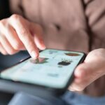 Woman's hands pointing to an item in an online shop on her smartphone, used in a post about FLIK