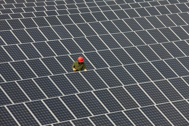 Man inspecting solar panels.