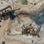 Aerial image of a leaky, decrepit oil well