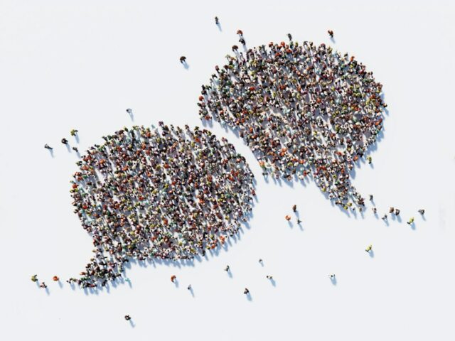 Human crowd forming a big speech bubble on white background; using