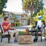 man chilling on patio with Kind Humanoid robot