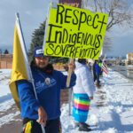 Man holds sign that says