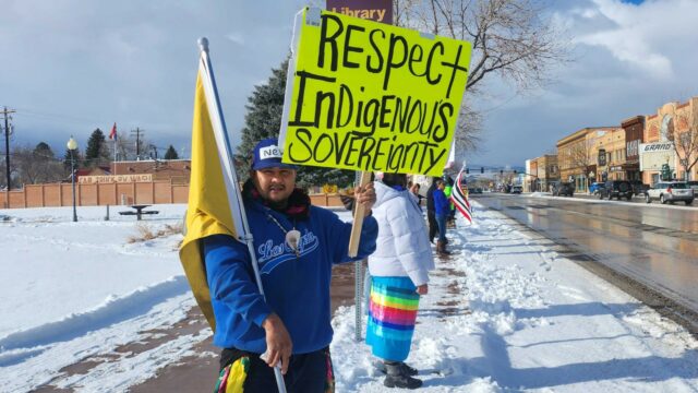 Man holds sign that says 