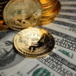 Bitcoin coins cryptocurrency on U.S. dollar banknotes background.