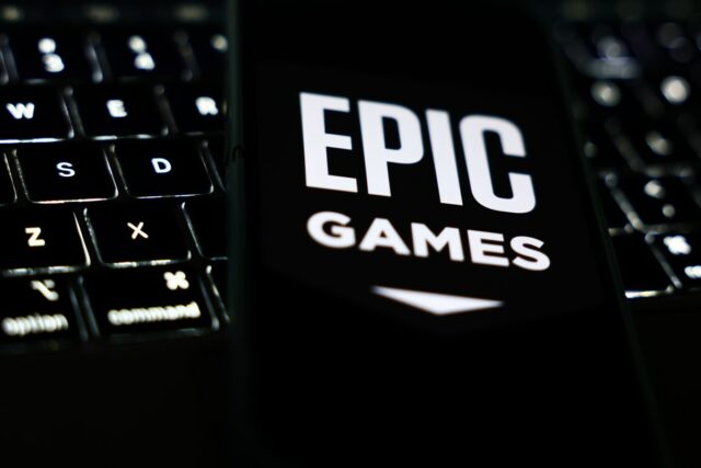 A laptop keyboard and Epic Games logo displayed on a phone screen are seen in this illustration photo taken in Krakow, Poland on October 1, 2024. (Photo by Jakub Porzycki/NurPhoto via Getty Images)