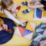 View from above of children playing with nursery teacher.