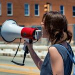 Female protestor with megaphone.