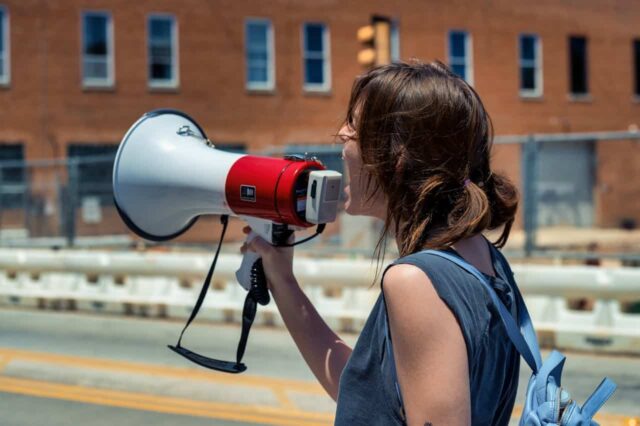 Female protestor with megaphone.