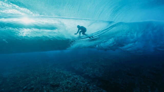 French surfer Joan Duru is glimpsed through the waves while competing in the 2024 Olympic Games in in Teahupo