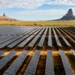 In an aerial view, the Kayenta Solar Plant is seen on June 23, 2024 in Kayenta, Arizona, with mountains in the background.