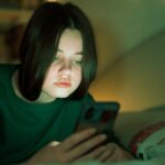 Portrait of a teenage girl looking at her mobile phone.