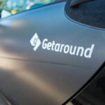 Logo for Getaround peer-to-peer car sharing service on the side of a car.