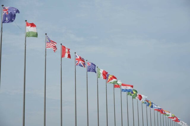 Line of flagpoles of different nationalities.