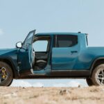 Blue Rivian R1T side view, driver door open