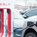 A car charges at a Tesla Supercharger