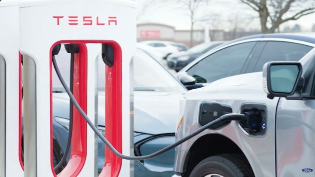 A car charges at a Tesla Supercharger